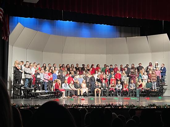 Students on stage singing